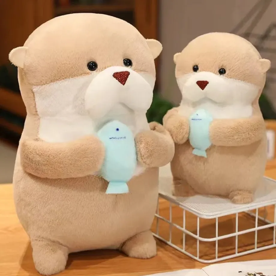 Peluche loutre tenant un poisson