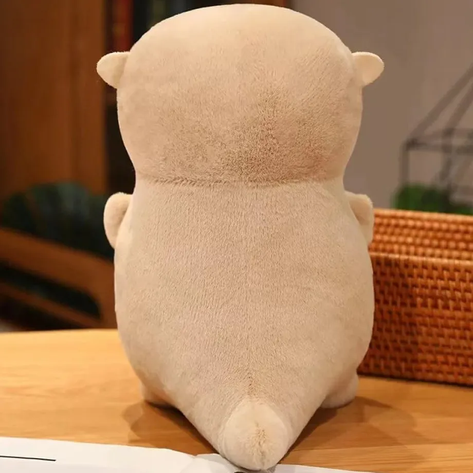 Peluche loutre tenant un poisson