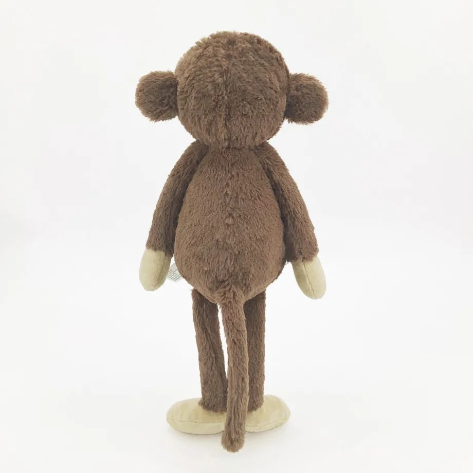 Peluche singe curieuse et attachante