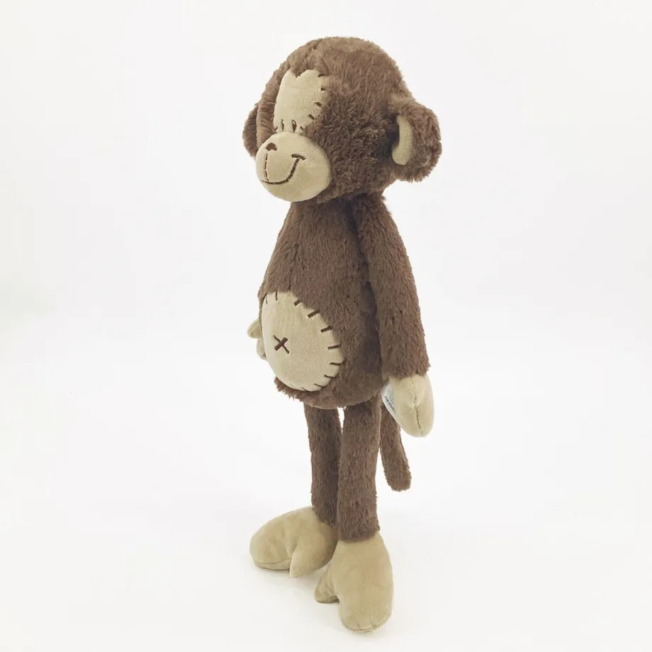 Peluche singe curieuse et attachante